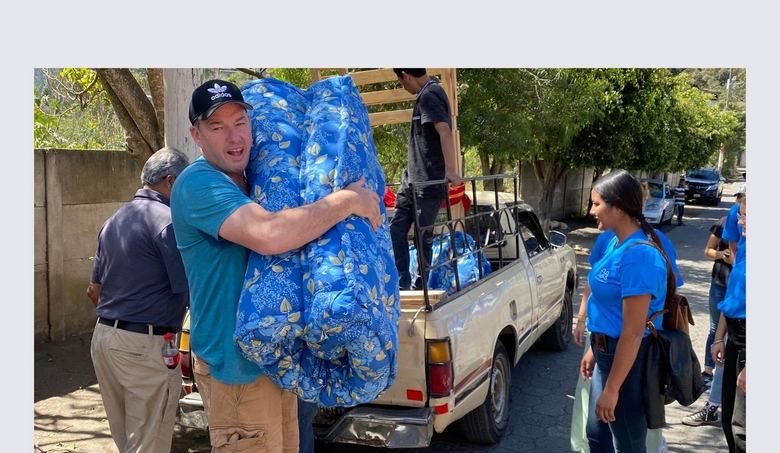Carrying a new mattress from the delivery truck