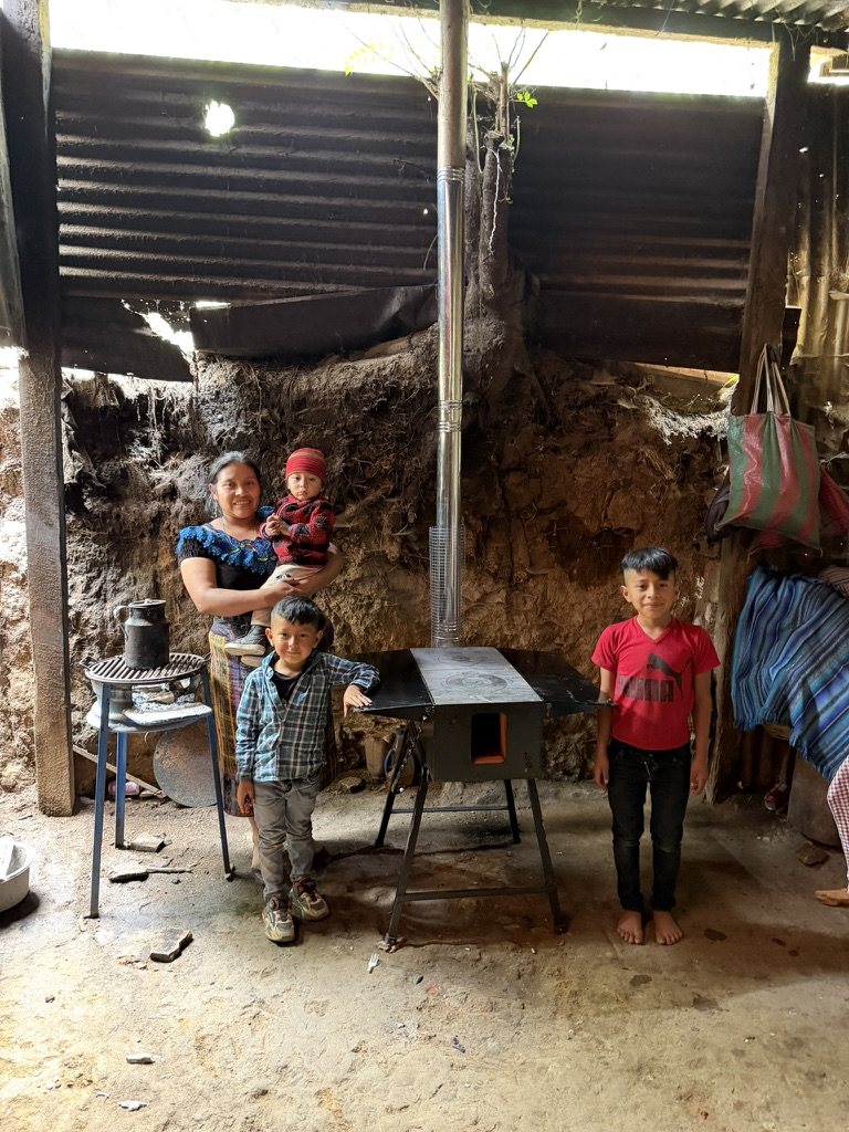A family standing beside their new vented stove